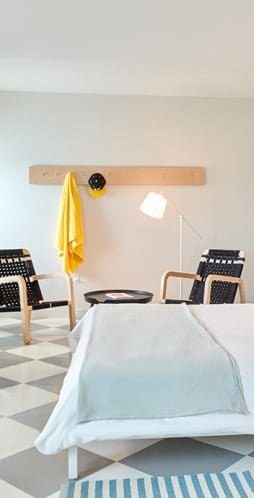 bedroom with desk, sitting area, and bed.