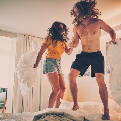 Couple Jumping on Bed