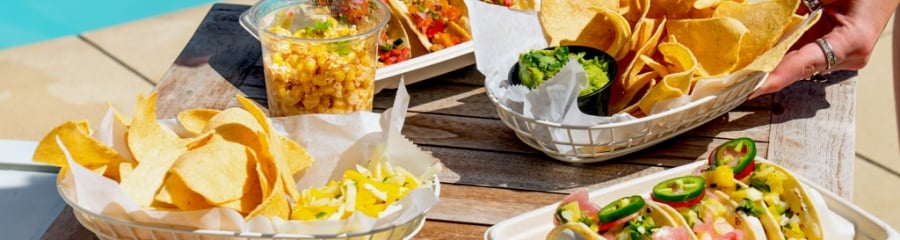Poolside dining at The Asbury: colorful tacos, chips, and guacamole for a vibrant social gathering in Asbury Park.