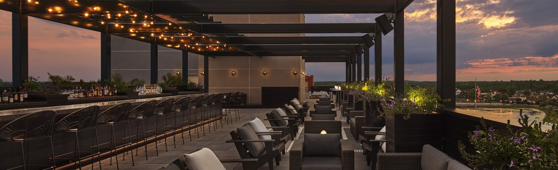 Experience sunset cocktails at The Baronet, Asbury Park's chic rooftop lounge with modern design and vibrant atmosphere.